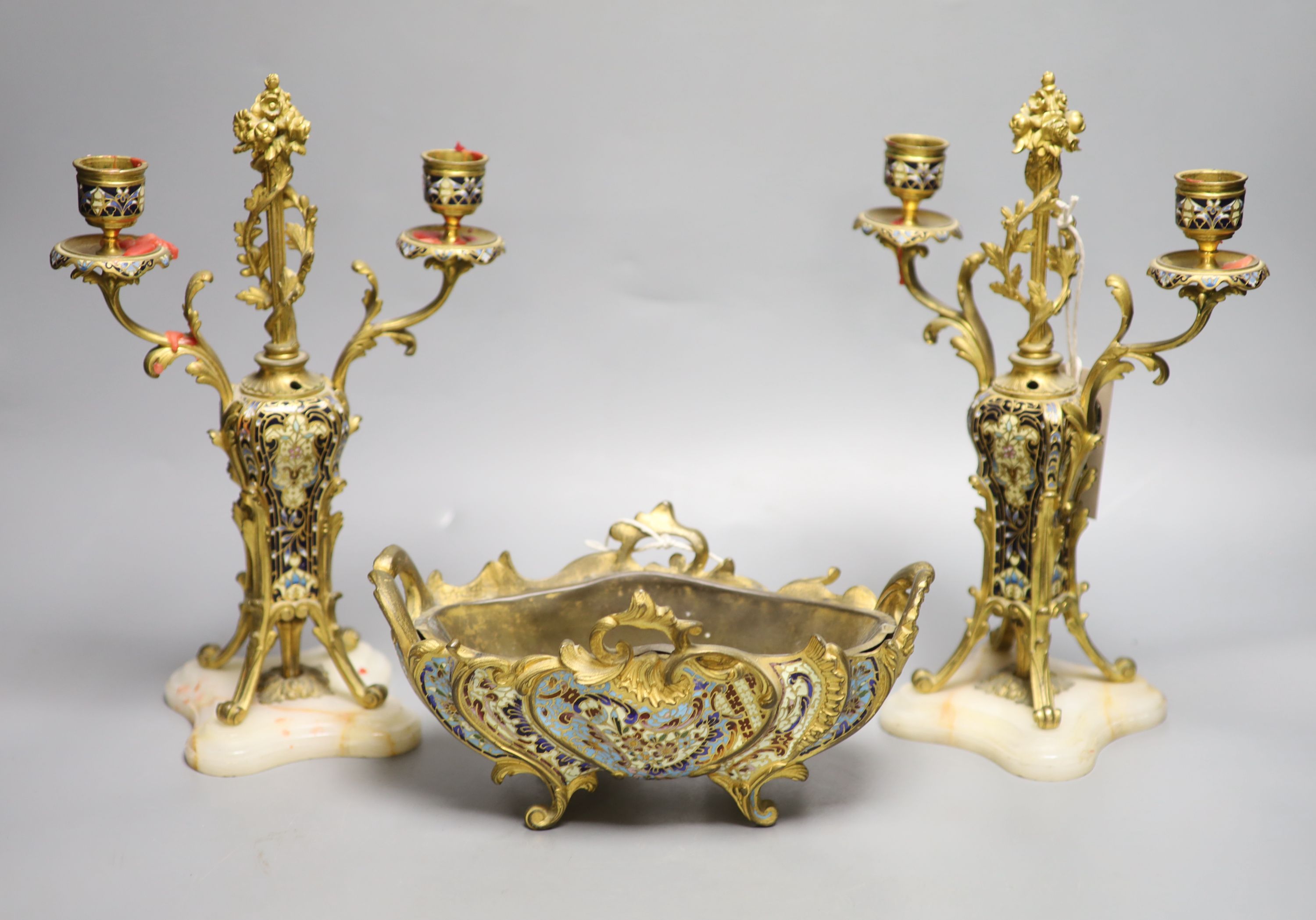 A pair of champleve enamel and alabaster candelabra, height 28cm and a similar jardiniere